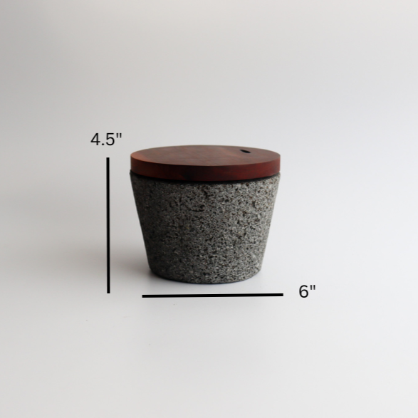 Studio CM | large volcanic stone mortar with a wooden top including a wooden pestle with a white background