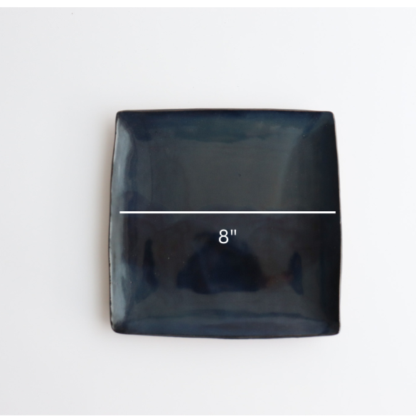 a handmade ceramic blue plate showing eight inch measurements