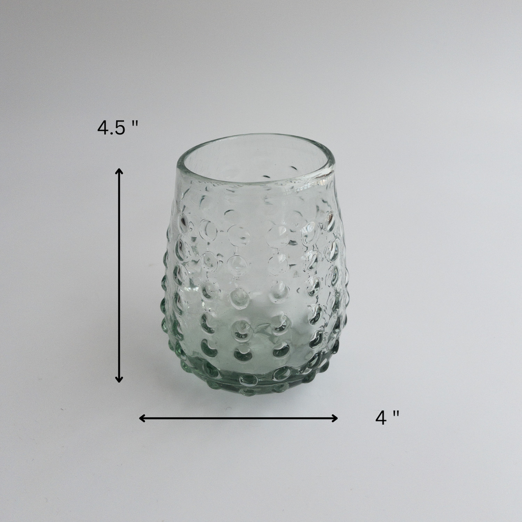 Studio CM | a round glass tumbler is handblown with glass dots adorning the exterior showing measurements of 4.5 x 4 "