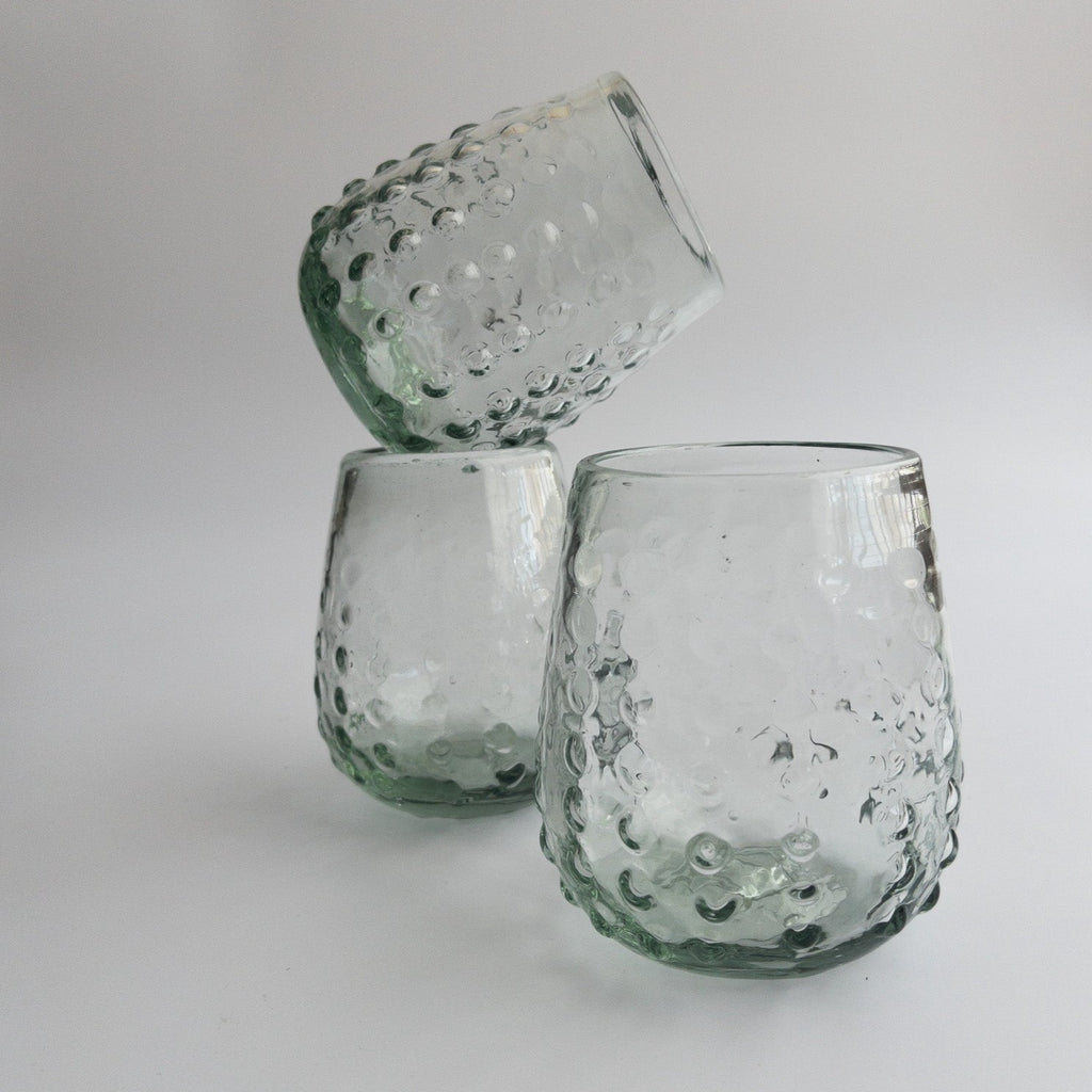 Studio CM | three round glass tumblers that are handblown with glass dots adorning the exterior