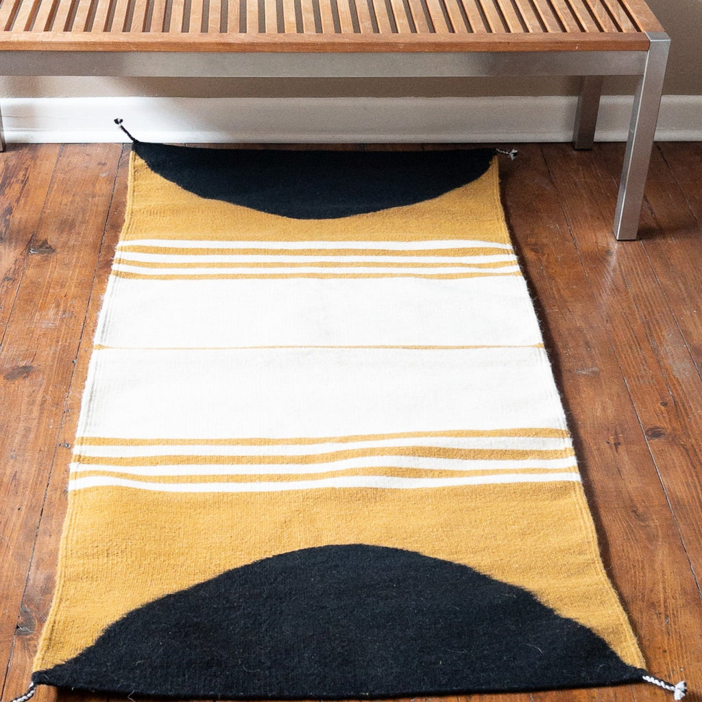 Studio CM | a yellow, cream and black handmade rug from Oaxaca. It is made by Zapotec 10th generation artisans. The rug is 100% natural materials.