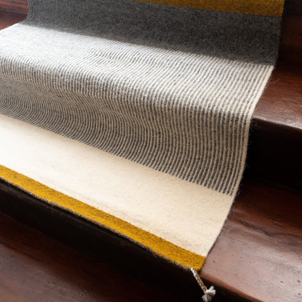 Studio CM | a beautiful hand made Zapotec rug made with a rich mustard yellow, cream and gray linear designs