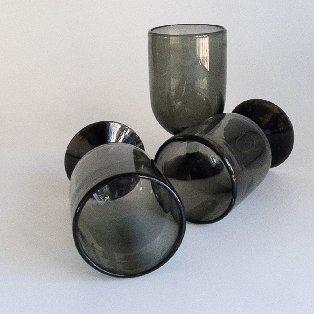 Studio CM | handblown black glass goblets that have a dark base and clear stem