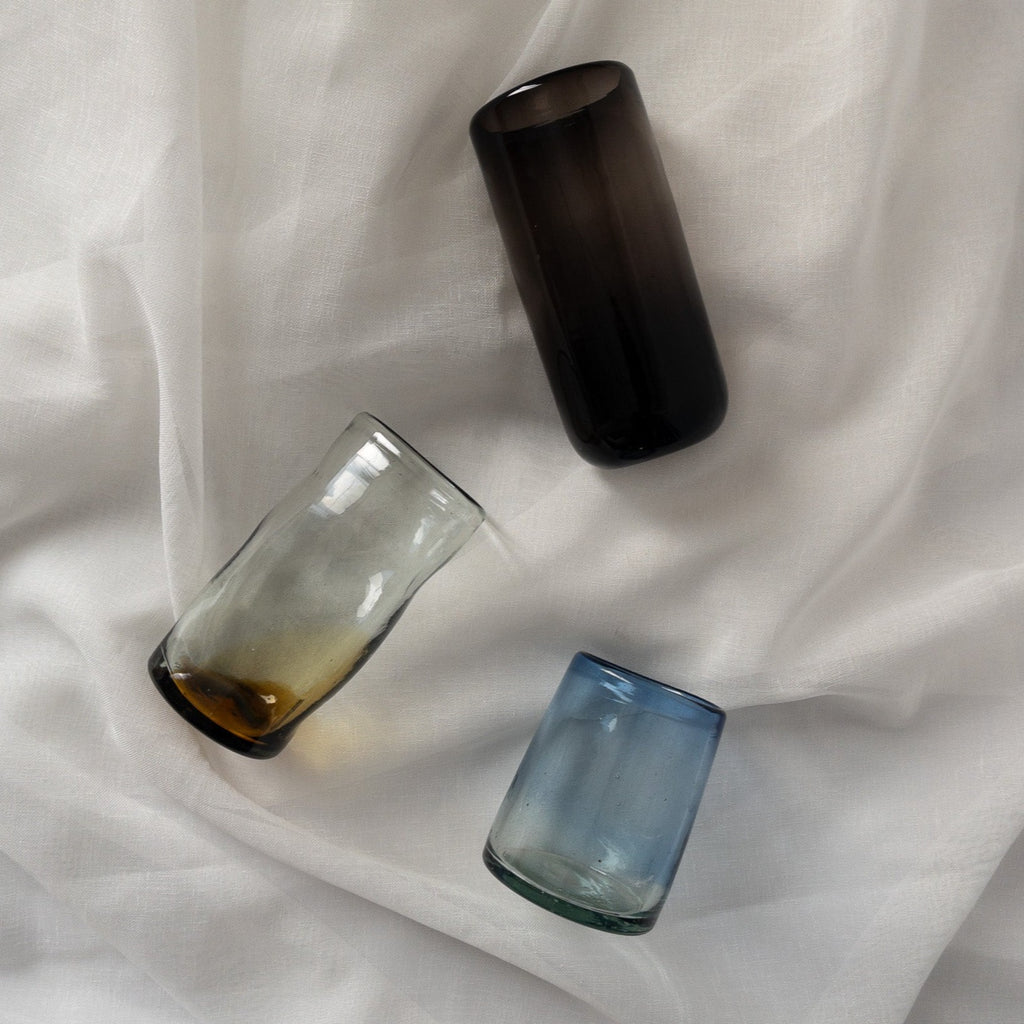 Studio CM | three handblown glasses that are different sizes in blue, black and brown