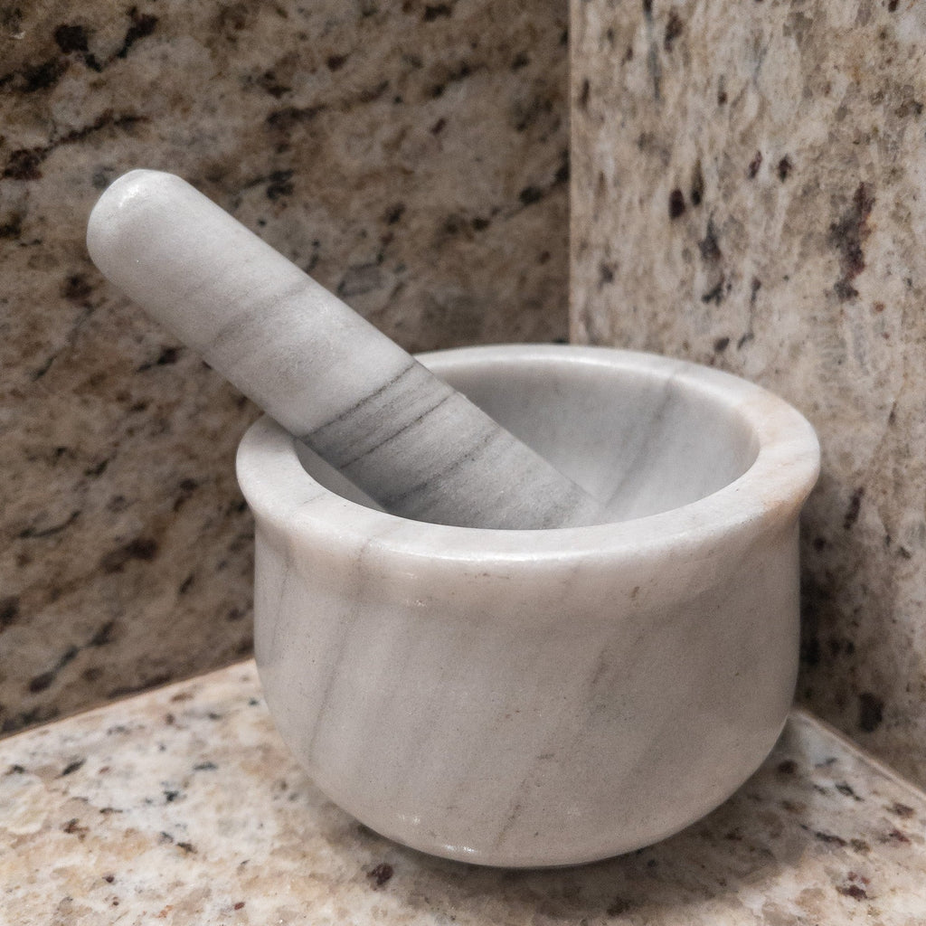 Studio CM | a large mortar and pestle made of gray marble