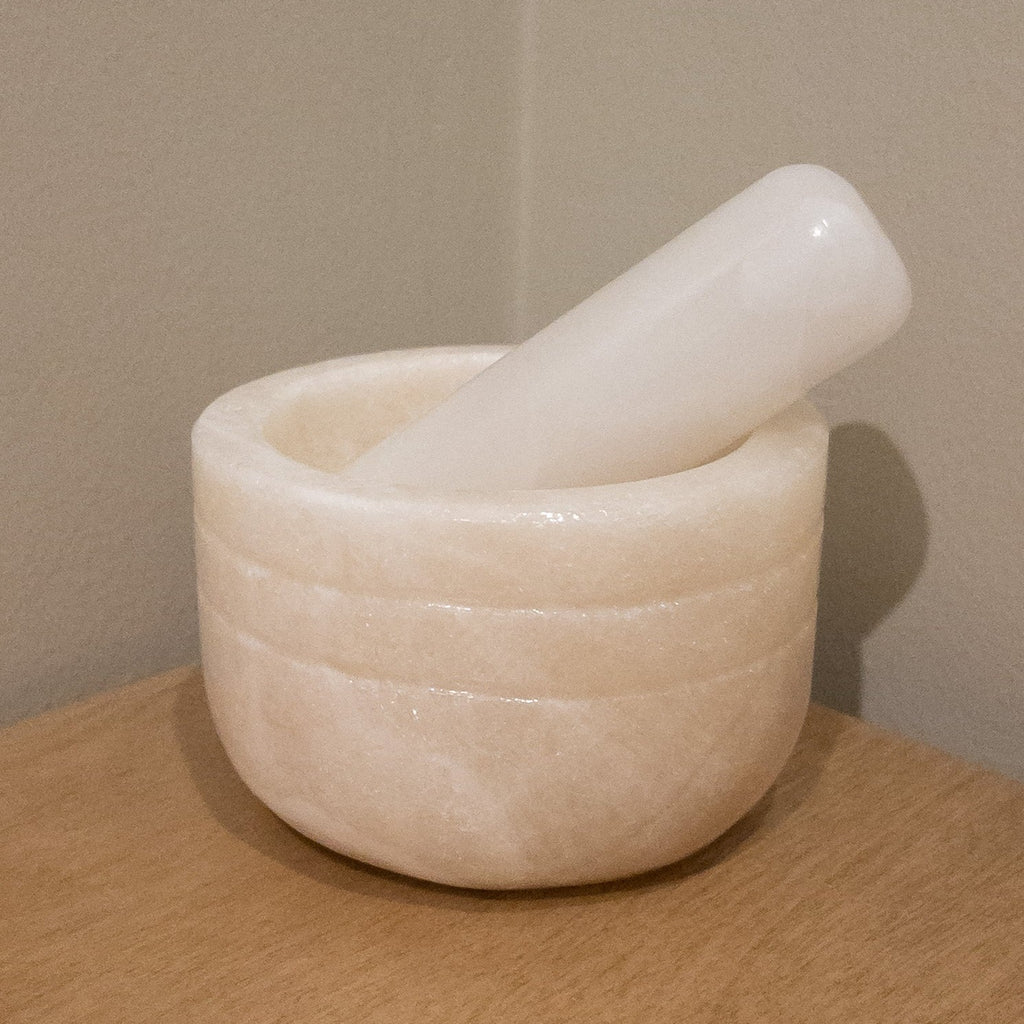 Studio CM | a large mortar and pestle made of white onyx