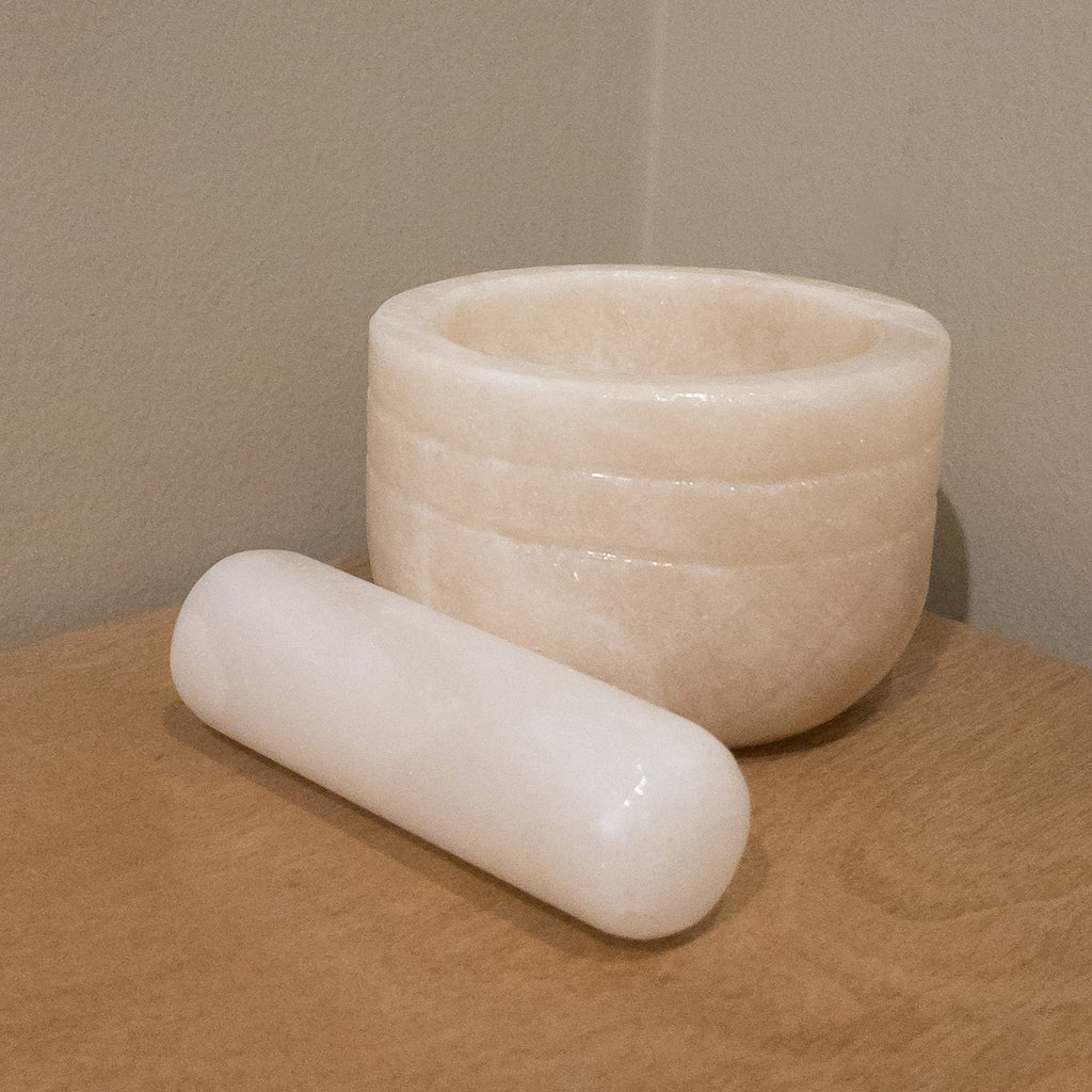 Studio CM | a large mortar and pestle made of white onyx