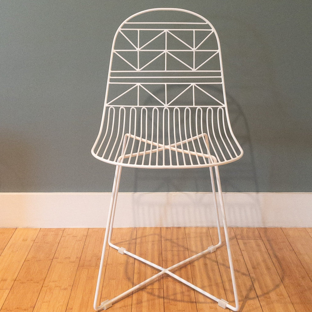 Studio CM | modern white rod iron chair with a light and delicate pattern