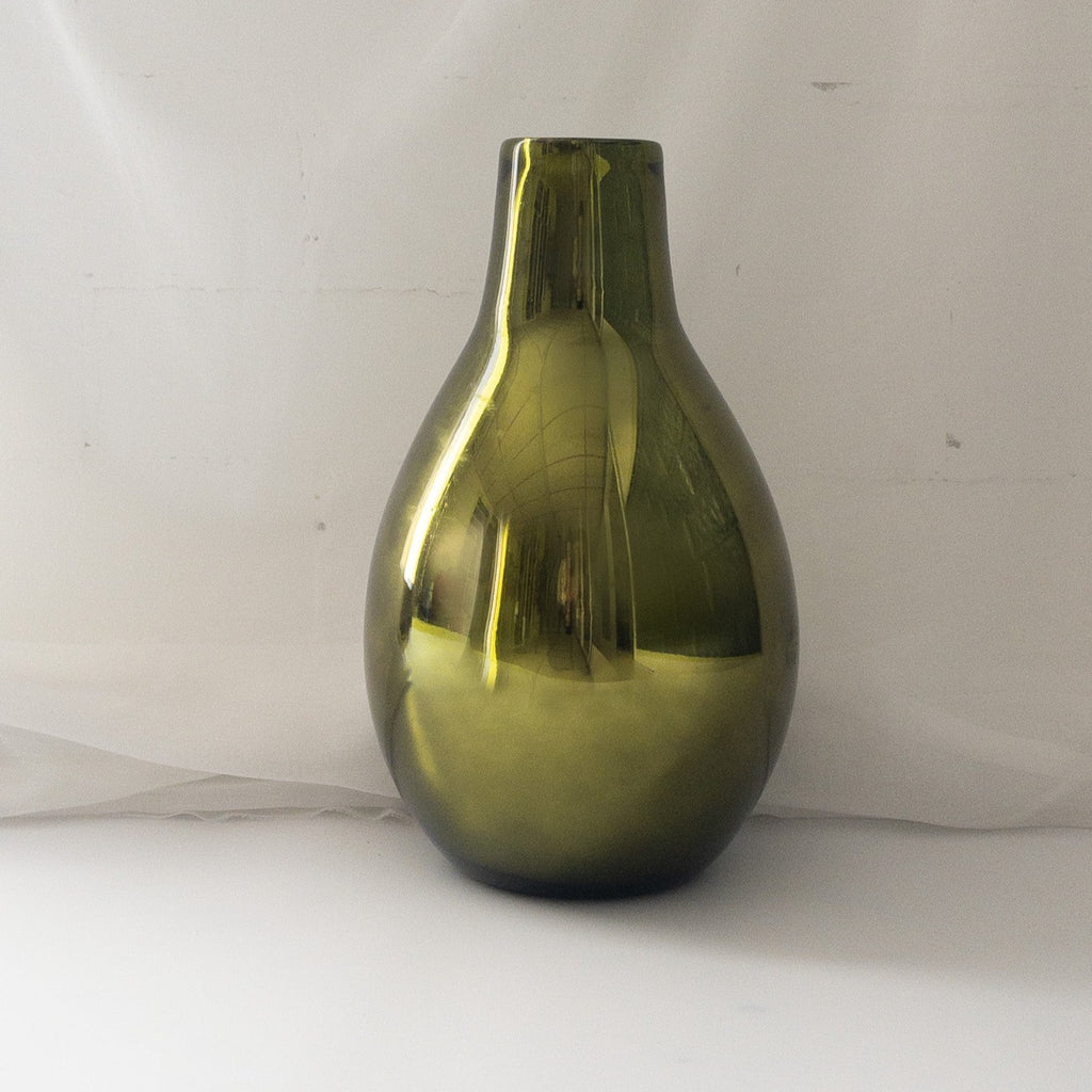 Studio CM | a metallic green hand blown vase in a teardrop shape