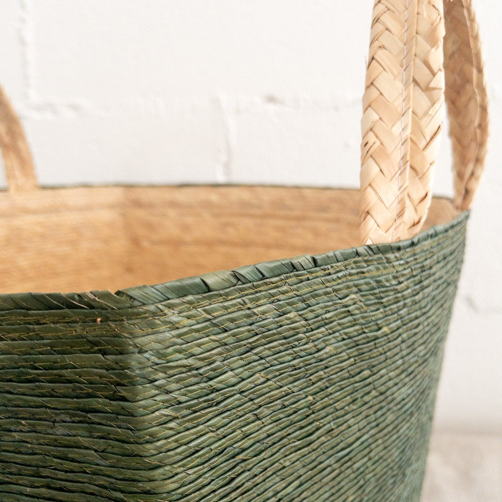 Studio CM | a palm basket that is made of all natural materials that has handles, a green exterior and generous size