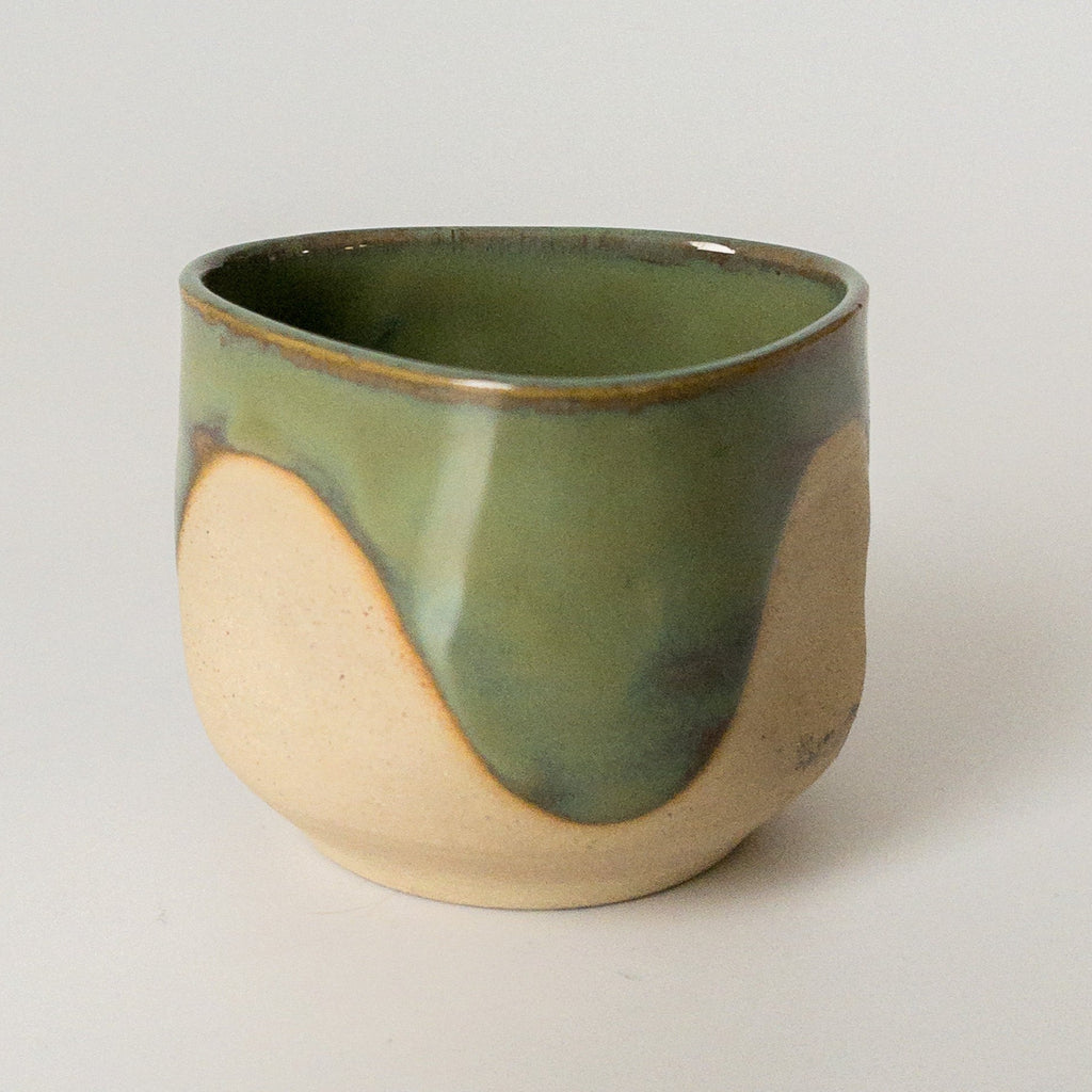 Studio CM | a triangle shaped mug that has green glaze and natural ceramic textures hand made in Texas