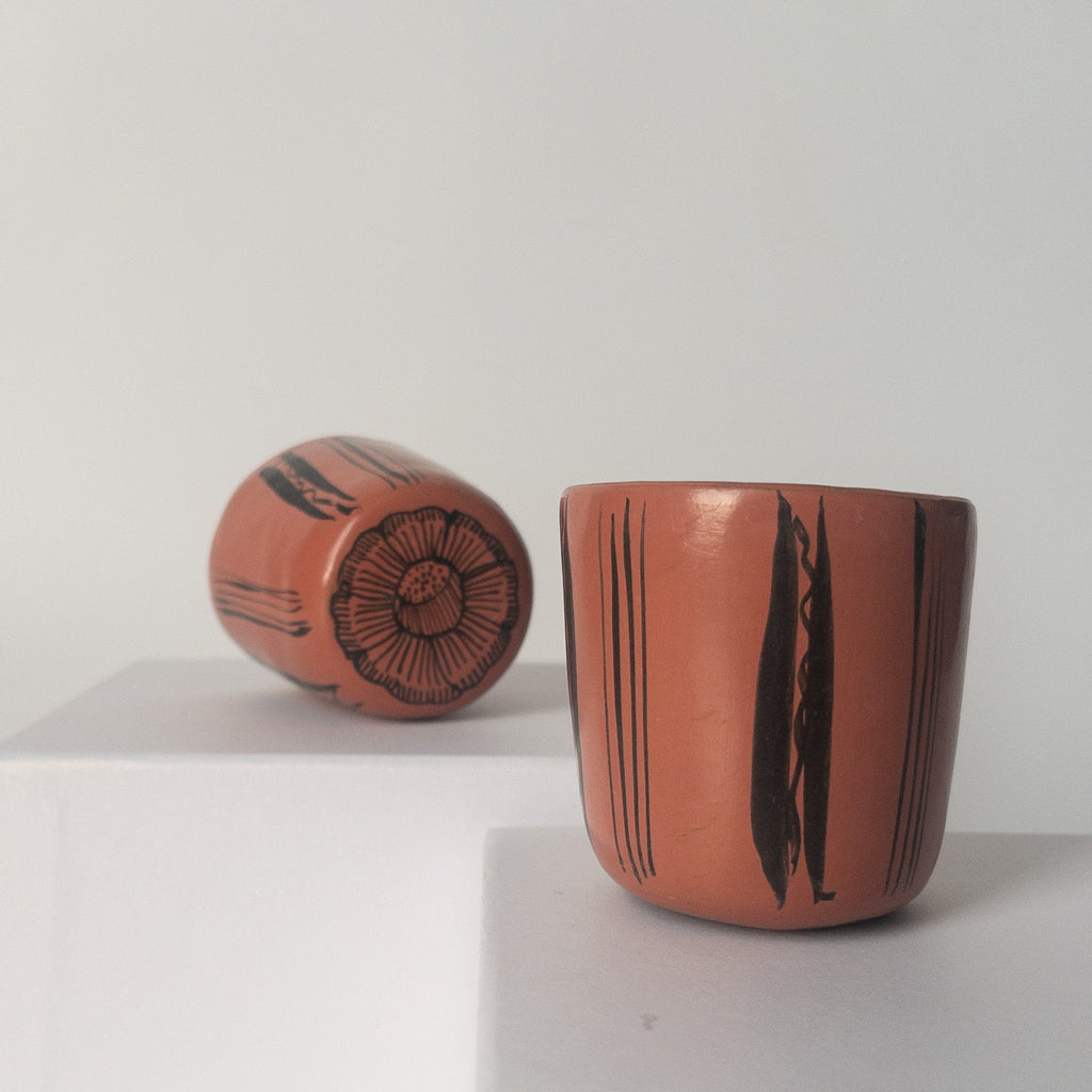 Studio CM | A pink ceramic cup that has hand painted designs in black ink made in Michoacan, Mexico