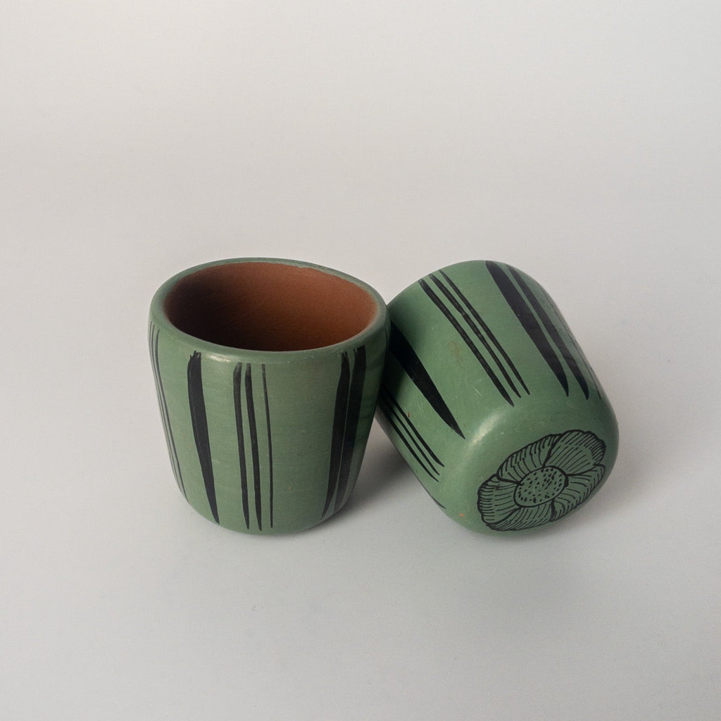 Studio CM | A teal ceramic cup that has hand painted designs in black ink made in Michoacan, Mexico