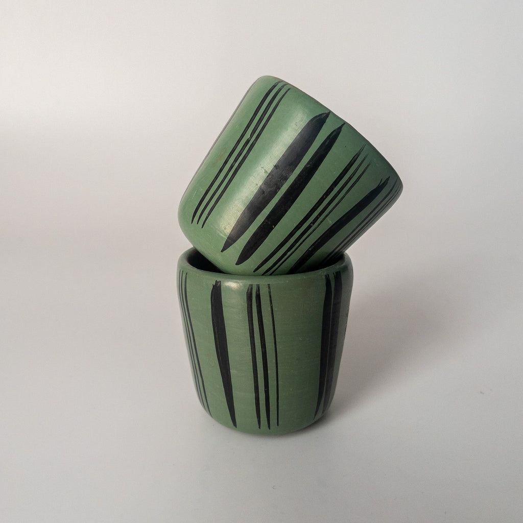 Studio CM | A teal ceramic cup that has hand painted designs in black ink made in Michoacan, Mexico