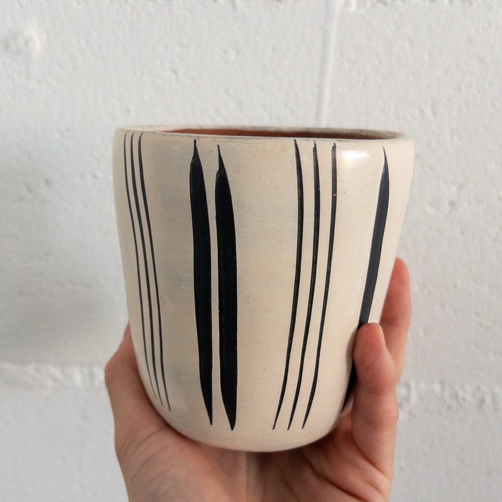 Studio CM | A white ceramic cup that has hand painted designs in black ink made in Michoacan, Mexico