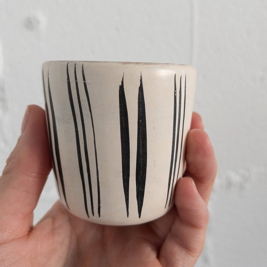 Studio CM | A white ceramic cup that has hand painted designs in black ink made in Michoacan, Mexico