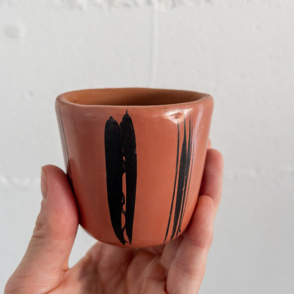 Studio CM | A pink ceramic cup that has hand painted designs in black ink made in Michoacan, Mexico