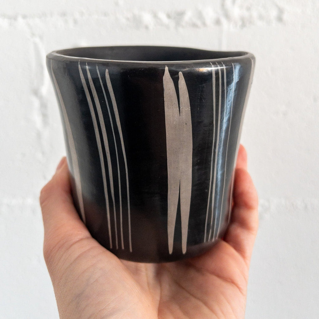 Studio CM | A black ceramic cup that has hand painted designs in gray ink made in Michoacan, Mexico