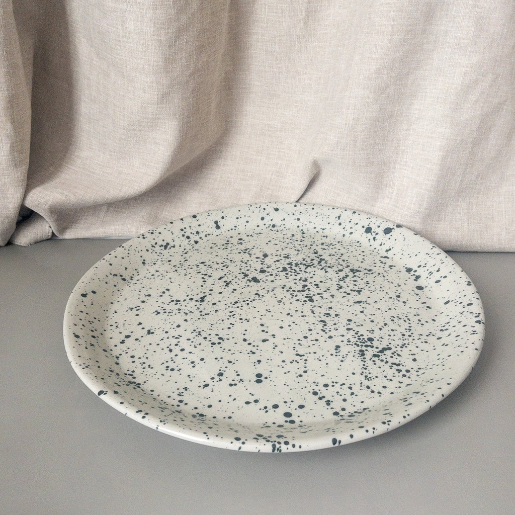 Studio CM | a ceramic plate that is gray and speckled blue meant to be used as a platter for a set of mugs made in Michoacan Mexico