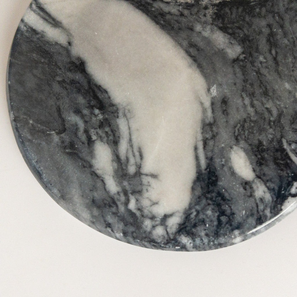 Studio CM | a set of gray marble coasters in a round shape