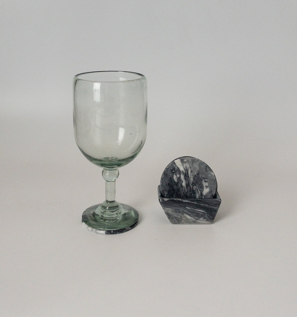 Studio CM | a black marble coaster set with a clear wine glass