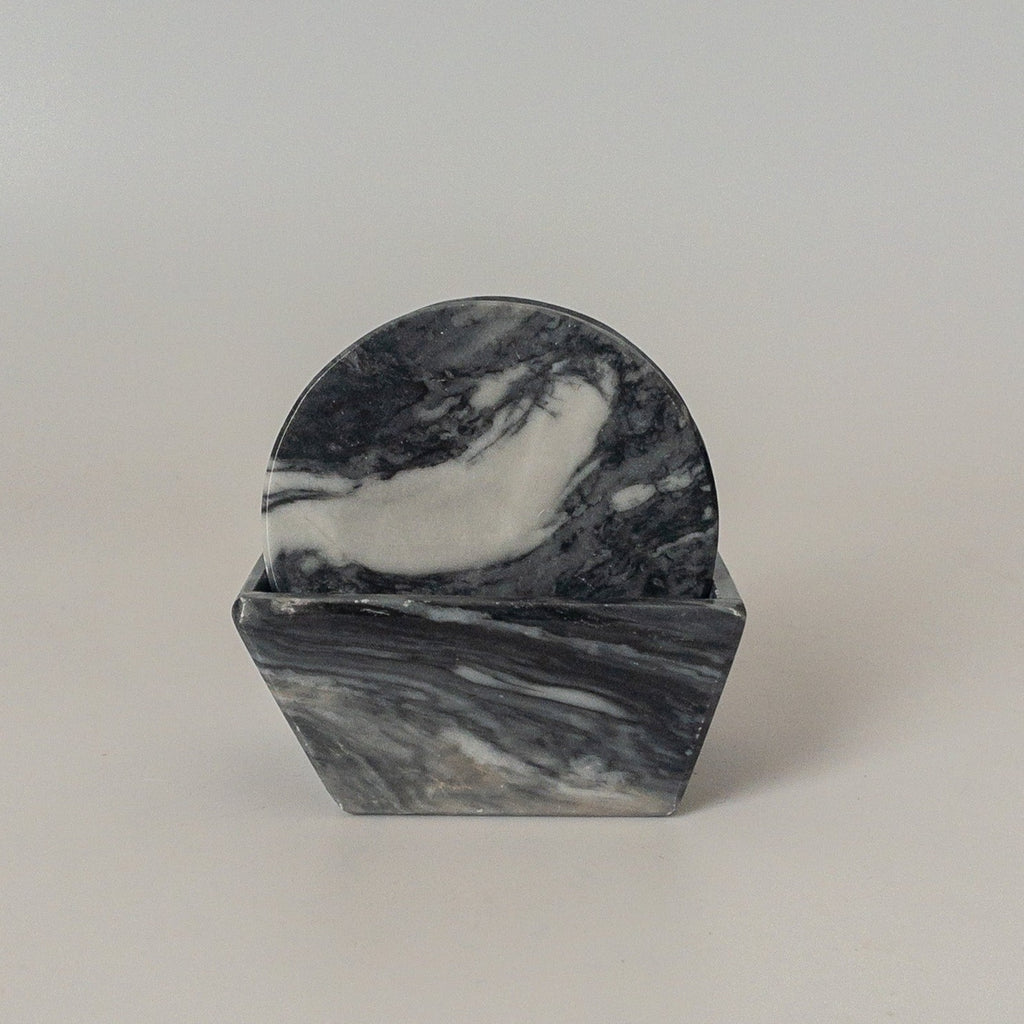 Studio CM | a set of gray marble coasters in a round shape 