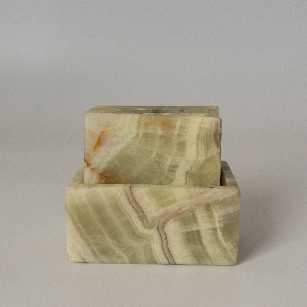 Studio CM | a set of green marble coasters in a square shape