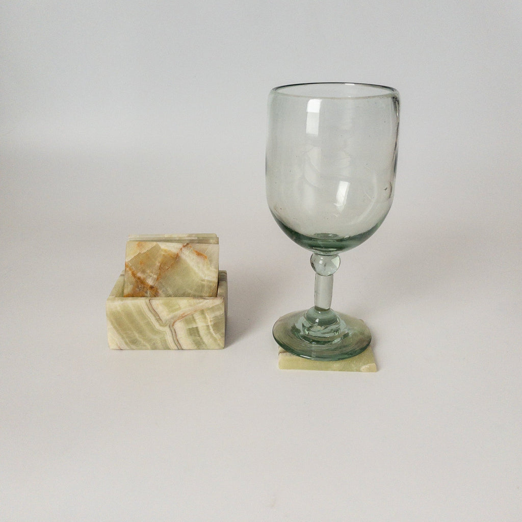 Studio CM | a set of green marble coasters in a square shape