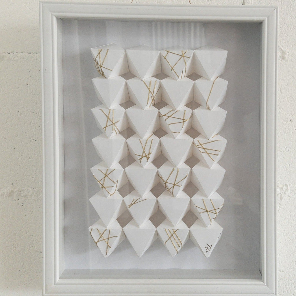 Studio CM | A hand made origami composition with a white monochromatic finish with a gold detail. Made my artist Alicia Lopez.