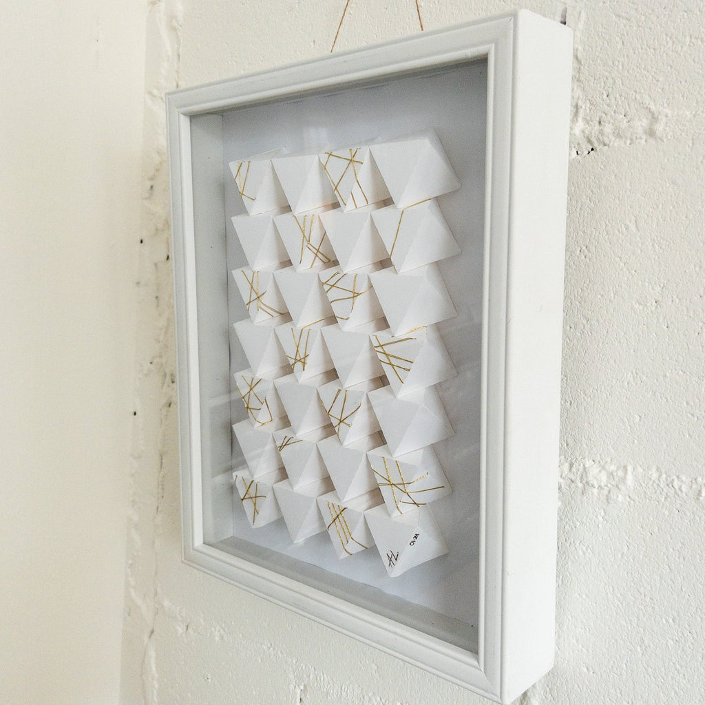 Studio CM | A hand made origami composition with a white monochromatic finish with a gold detail. Made my artist Alicia Lopez.