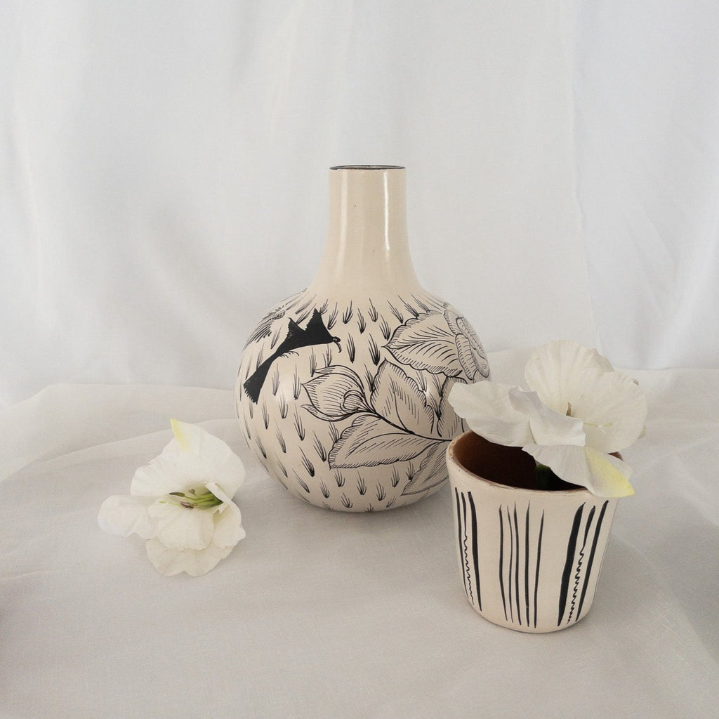 Studio CM | A hand painted ceramic carafe including it's drinking cup. It is made of ceramic and hand painted with flowers and birds. Made in Michoacan, Mexico. 