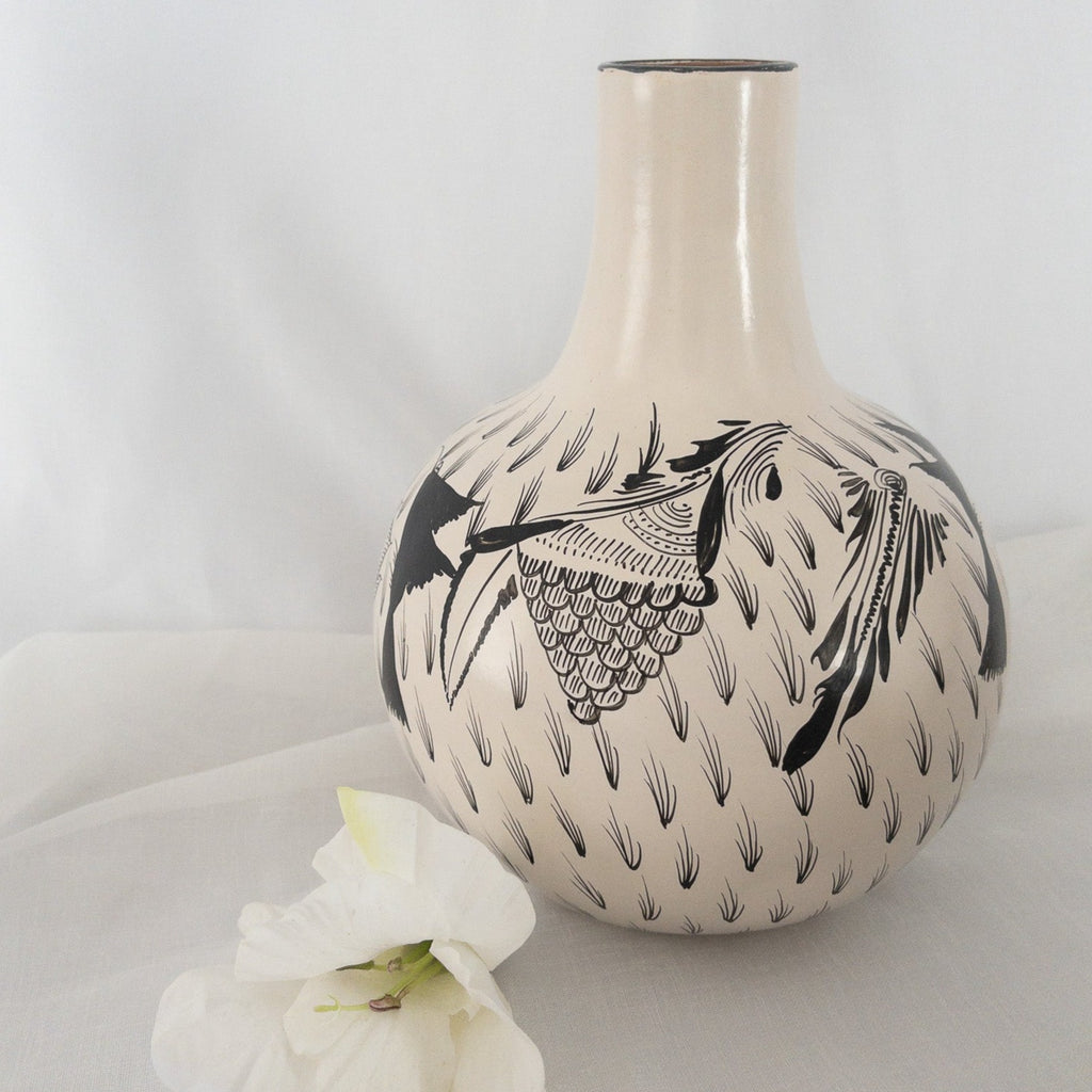 Studio CM | A hand painted ceramic carafe including it's drinking cup. It is made of ceramic and hand painted with flowers and birds. Made in Michoacan, Mexico. 