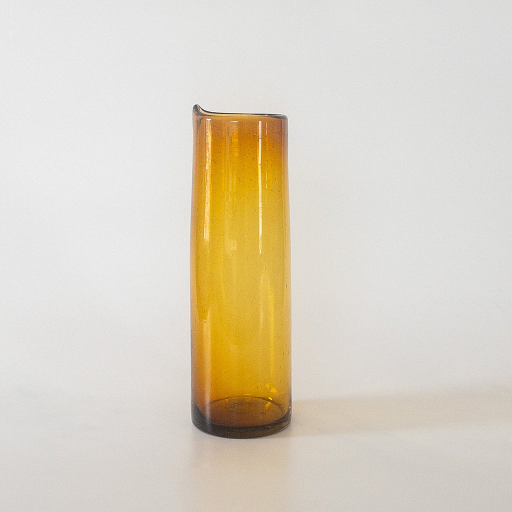 Studio CM | A handblown amber cylindrical pitcher made from recycled glass in Jalisco, Mexico