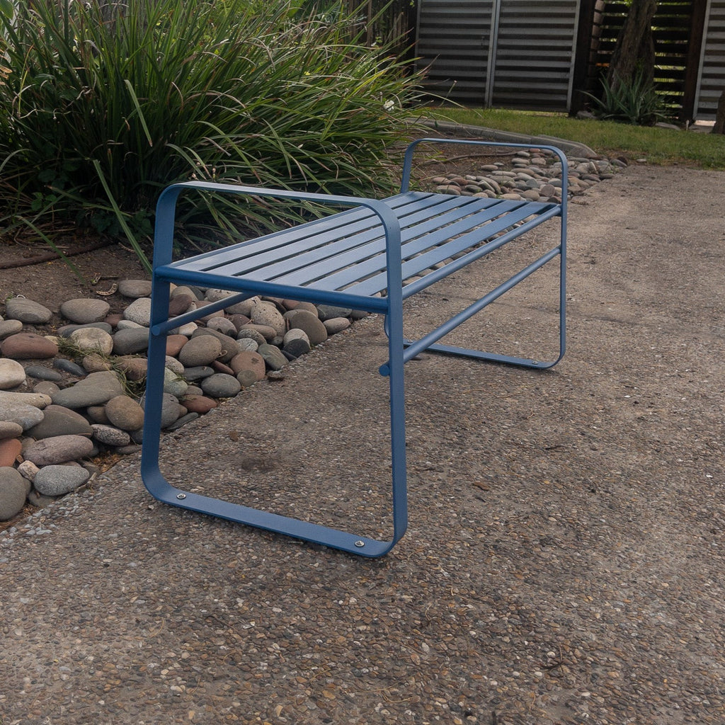 Studio CM | A contemporary blue metal bench made of steel in an outside space. The bench is hand made in Guadalajara, Mexico. 