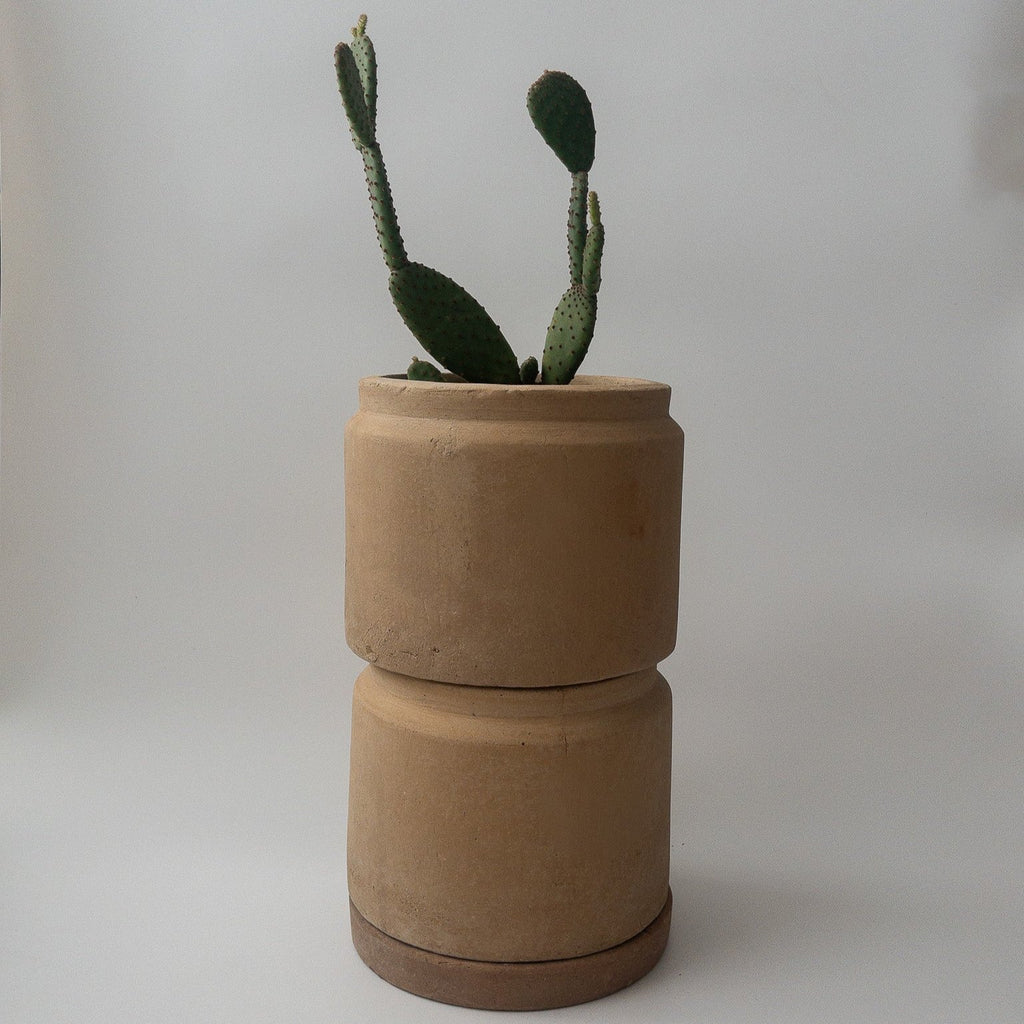 Studio CM | A short cylindrical and modern planter made of terracotta that comes with it's matching dish