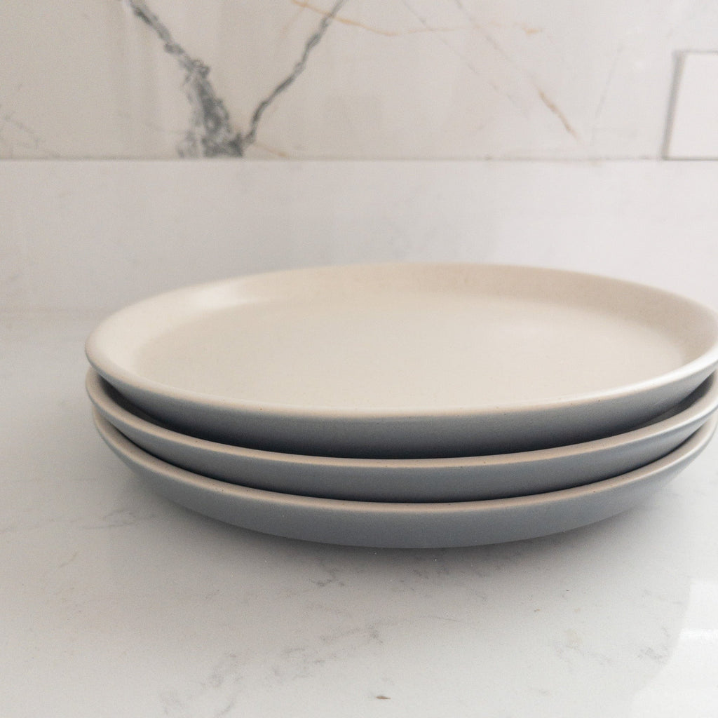 Studio CM | A dinner plate with a white top and light blue base made by hand in Mexico City