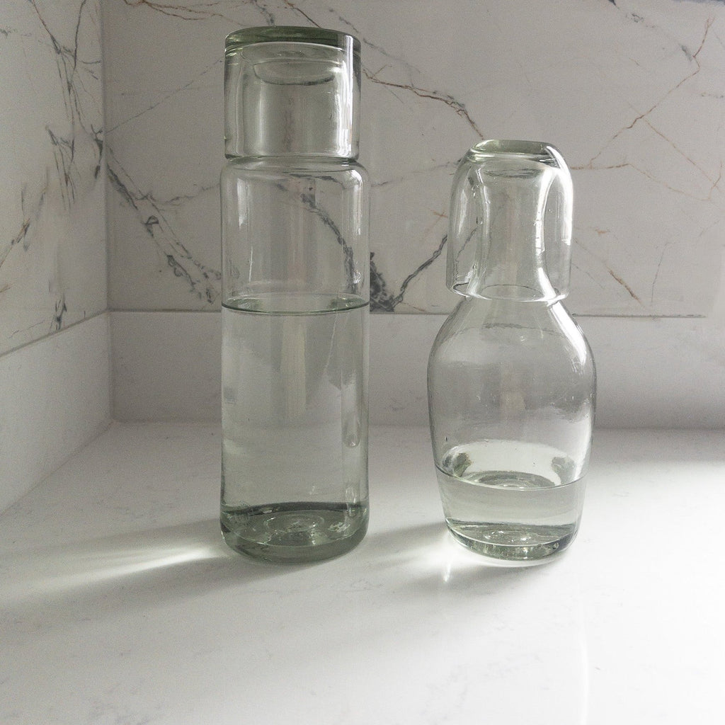 Studio CM | Two clear carafes that have their cup. Handblown glass from Jalisco, Mexico