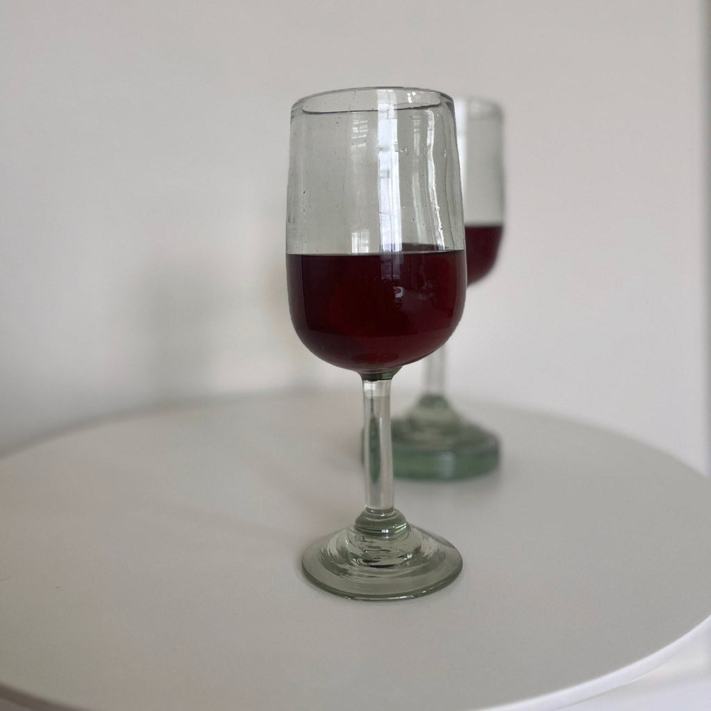 Studio CM | Wine glass with red wine on a white surface