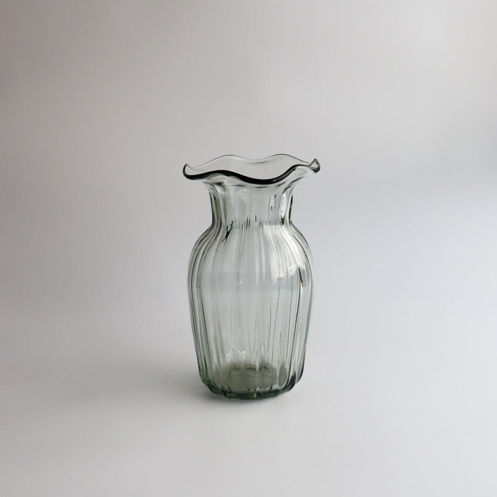 Studio CM | a handblown clear vase with a wavy abstract opening shape