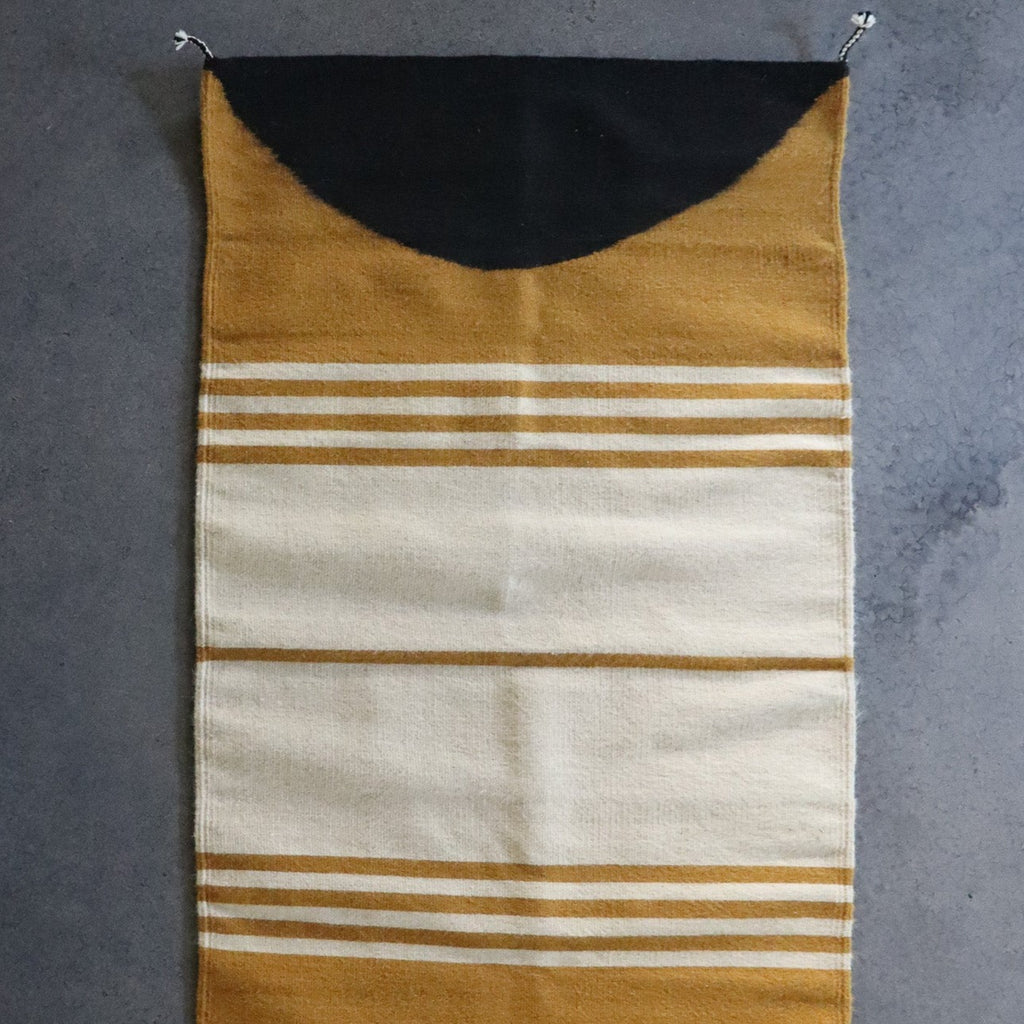 Studio CM | a yellow, cream and black handmade rug from Oaxaca. It is made by Zapotec 10th generation artisans. The rug is 100% natural materials.