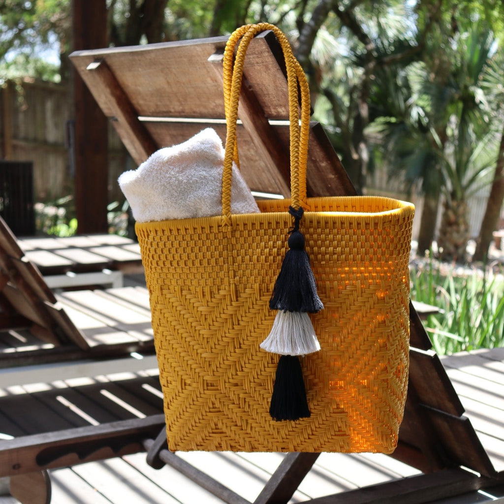 Studio CM | A handwoven plastic tote that is a yellow color made in Jalisco, Mexico