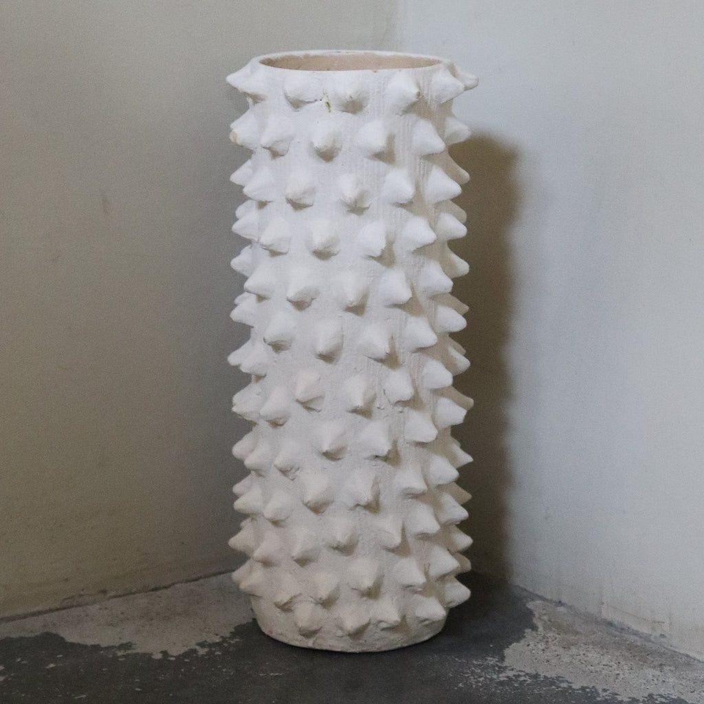 Studio CM | white ceramic planter that is cylindrical and has spike design details resembling the Mexican ceiba tree