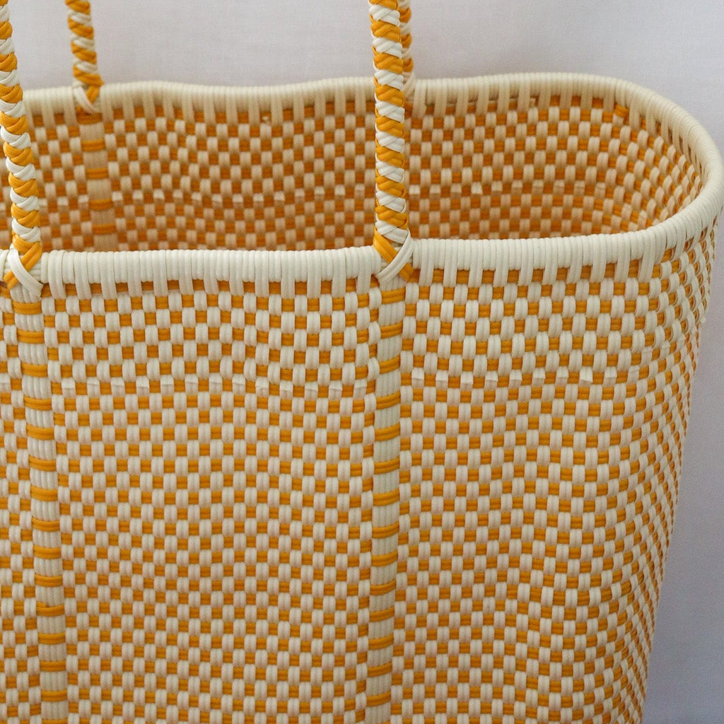 Studio CM | A large handwoven plastic tote that is a white and yellow made in Jalisco, Mexico