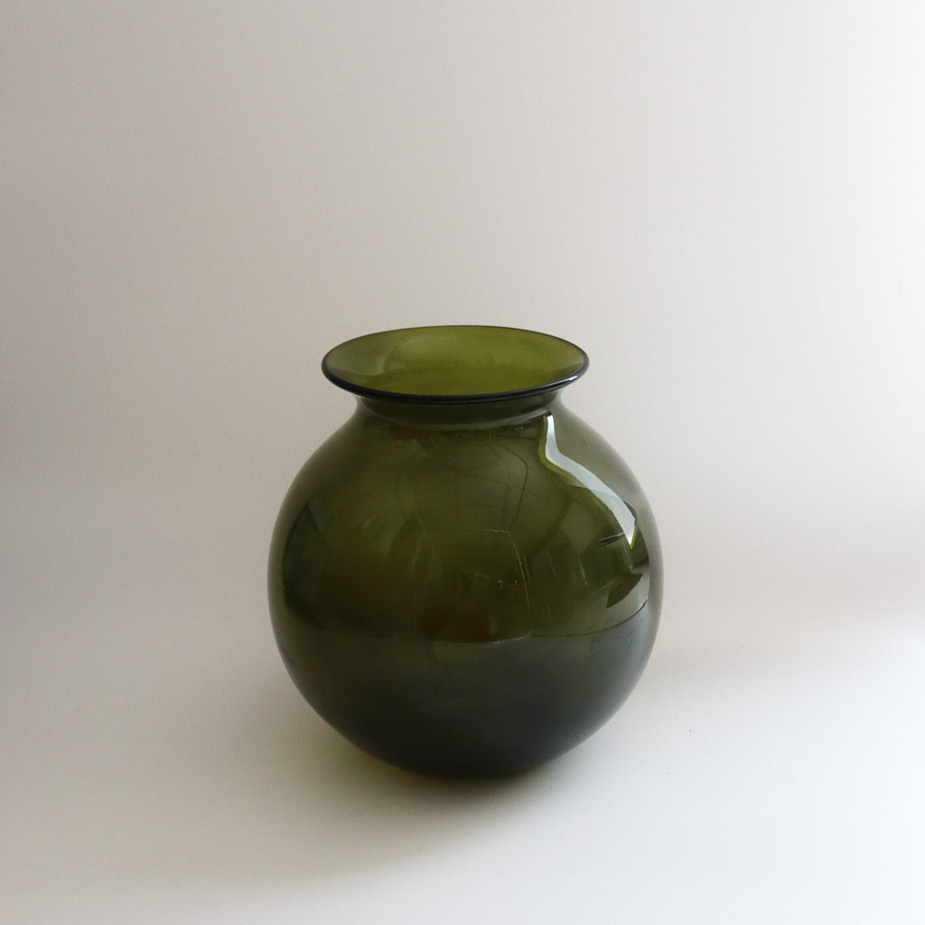 Studio CM | A green handblown vase that is green and round with a wide opening