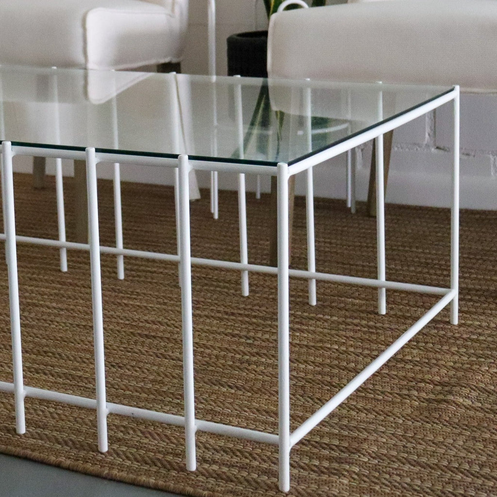 Studio CM | a modern rod iron coffee table that is made with metal parallel legs and a tempered glass top to size. The product is welded in Guadalajara Mexico