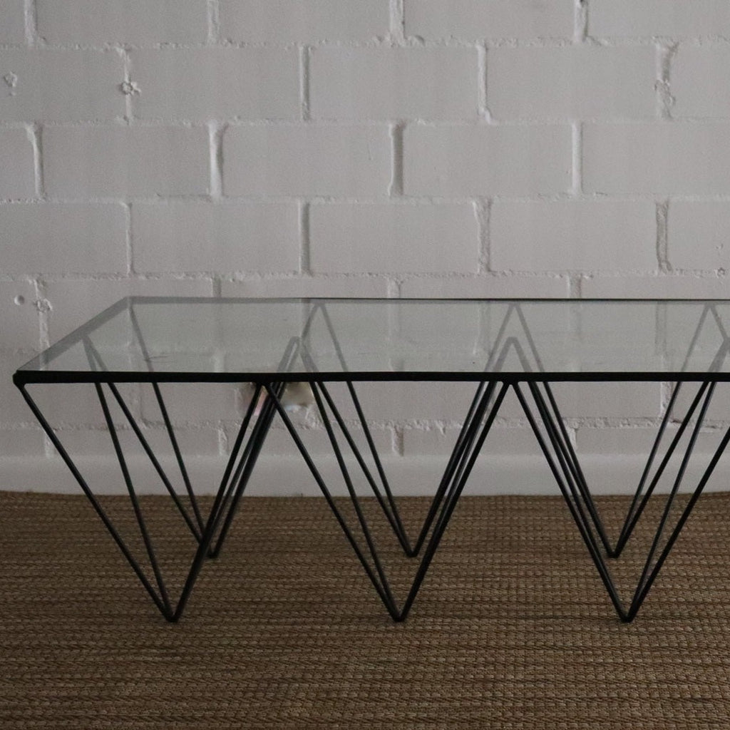 Studio CM | a modern rod iron coffee table that is made with metal triangular legs and a tempered glass top to size. The product is welded in Guadalajara Mexico