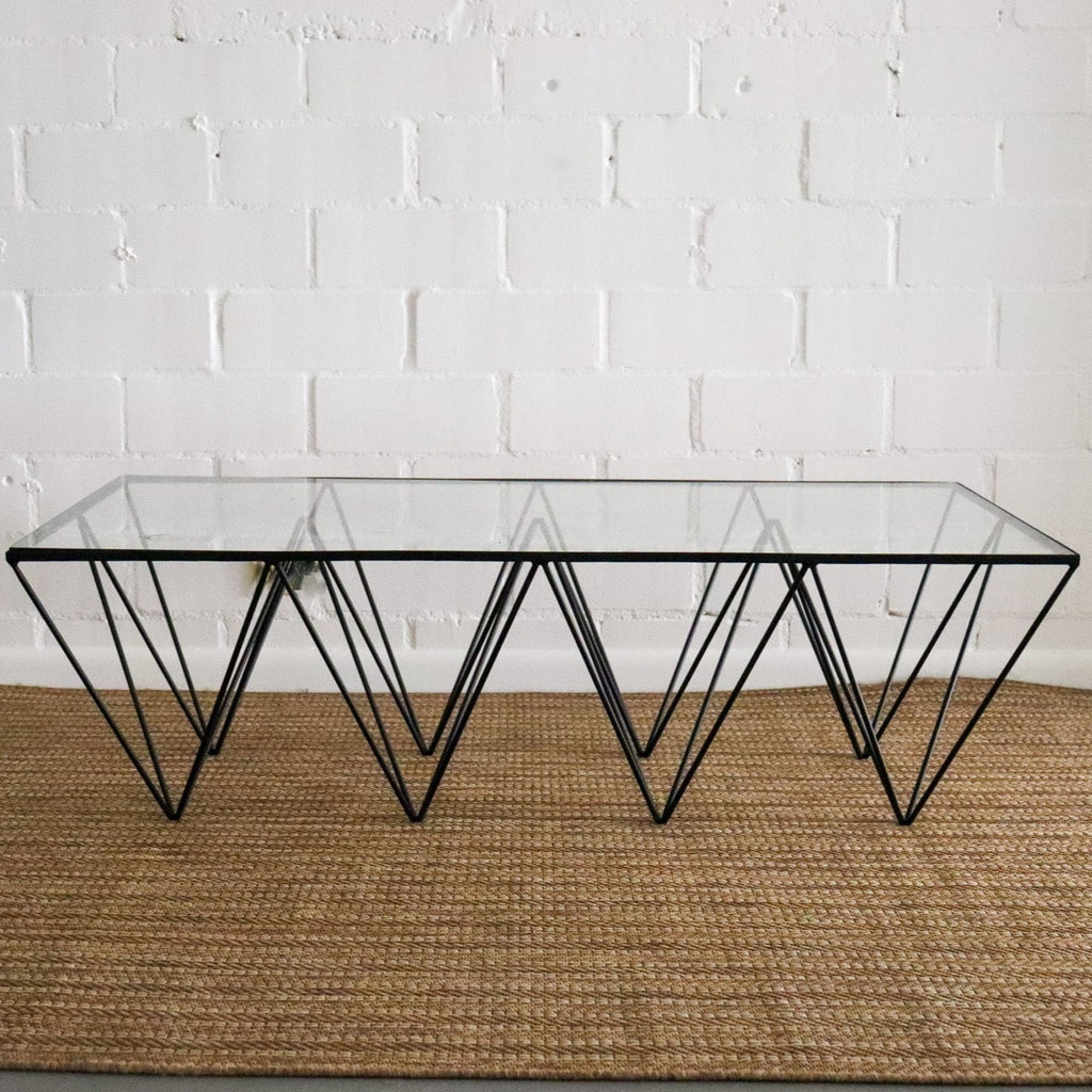 Studio CM | a modern rod iron coffee table that is made with metal triangular legs and a tempered glass top to size. The product is welded in Guadalajara Mexico