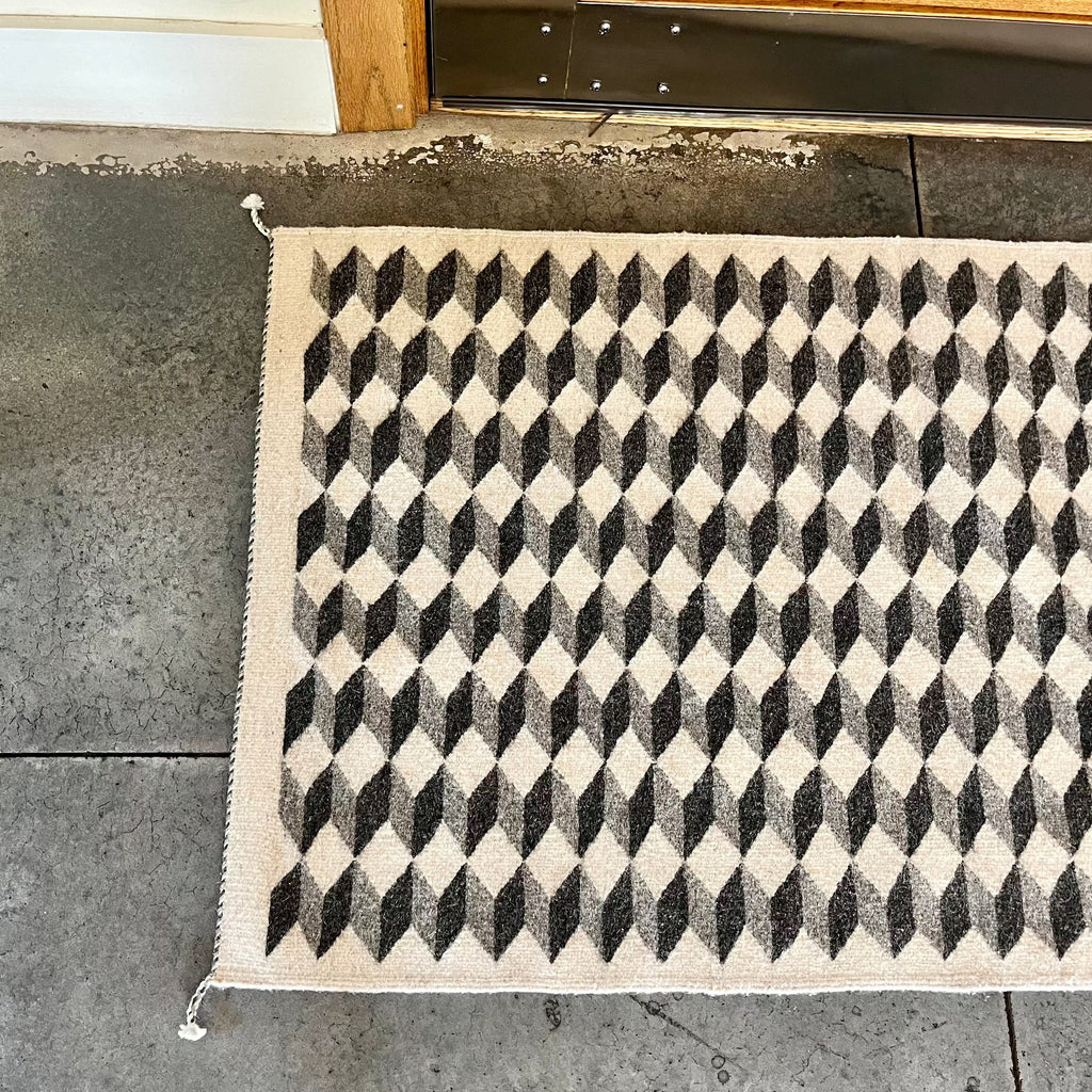 Studio CM | a 5 by 3 foot geometric gray rug. It was handmade in Oaxaca and is made of 100% natural dues and wool. It's gorgeous and washable meant to last. 