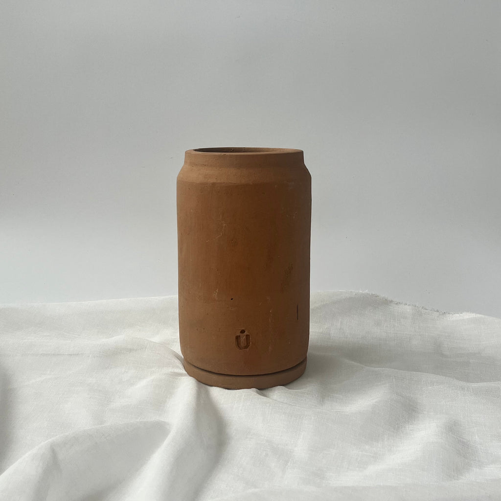 Studio CM | A terracotta long tall cylinder planter with its ceramic dish