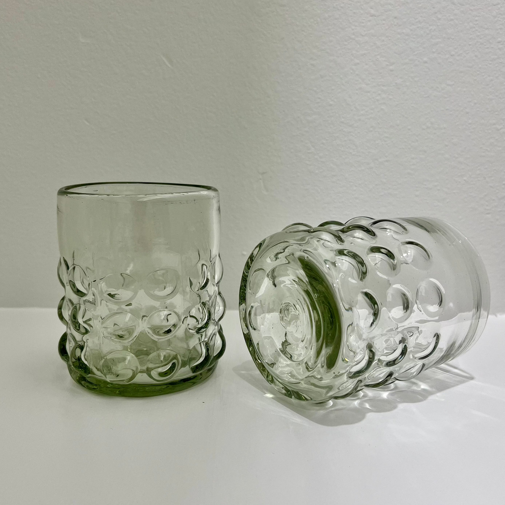 Studio CM | two glass tumblers that are handblown with glass dots adorning the exterior. they are artisan made in jalisco mexico. 